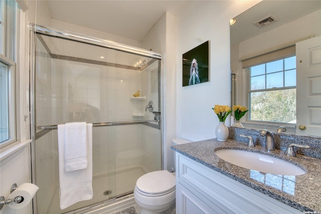 bathroom with vanity, toilet, and an enclosed shower