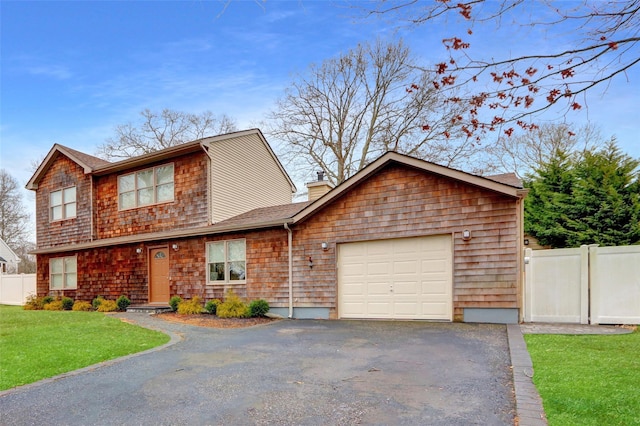 view of front of house featuring a garage and a front lawn