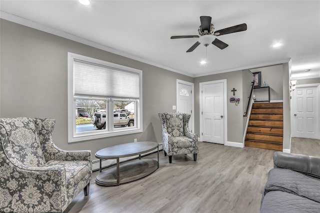 interior space featuring ornamental molding, ceiling fan, baseboard heating, and light hardwood / wood-style flooring