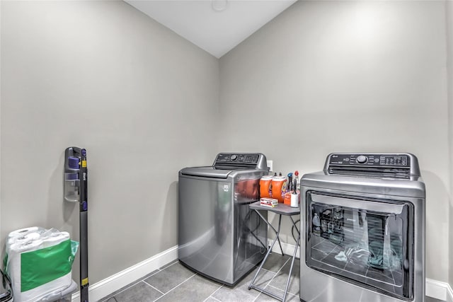 washroom with tile patterned floors and washer and clothes dryer