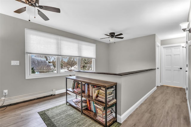 interior space with light hardwood / wood-style flooring and baseboard heating