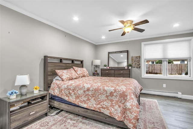 bedroom with baseboard heating, ceiling fan, crown molding, and light hardwood / wood-style floors