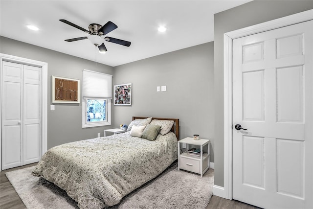 bedroom with hardwood / wood-style flooring, ceiling fan, and a closet