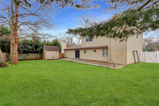 rear view of house with a storage unit, a deck, and a lawn