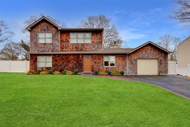 view of front of home with a garage and a front lawn