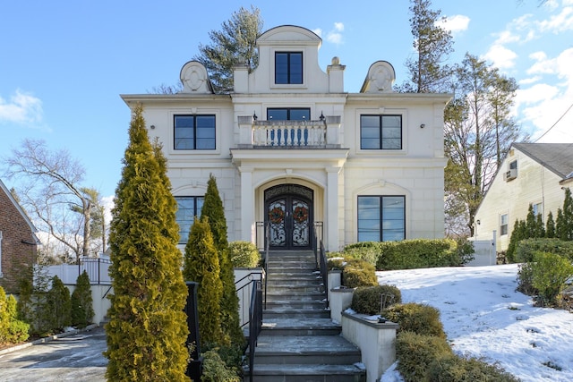 french country inspired facade featuring french doors and a balcony