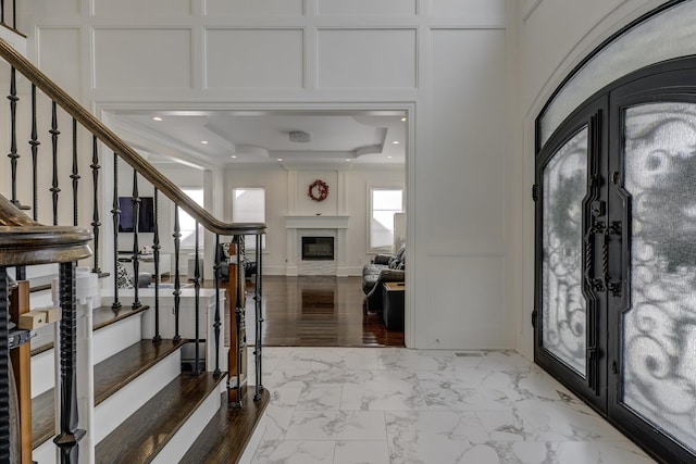 entrance foyer featuring french doors and a raised ceiling