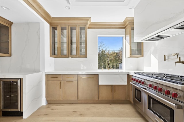 kitchen with wine cooler, double oven range, ventilation hood, and light hardwood / wood-style flooring