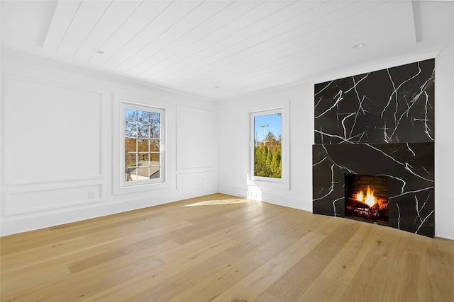 unfurnished living room featuring wood-type flooring and wooden ceiling