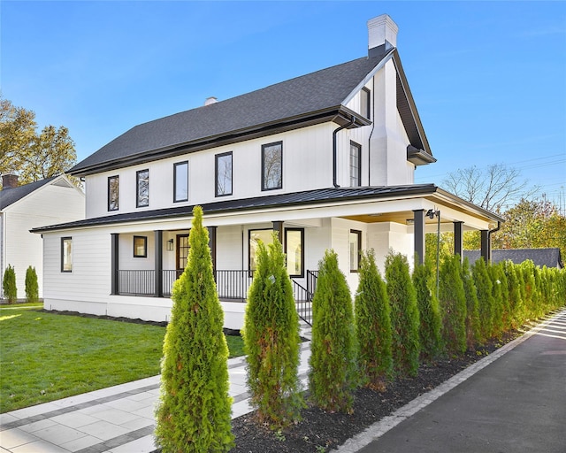 exterior space featuring a lawn and a porch