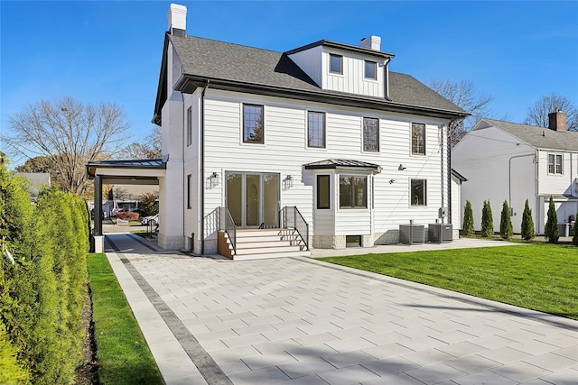 view of front facade with roof with shingles, central AC unit, a chimney, and a front yard