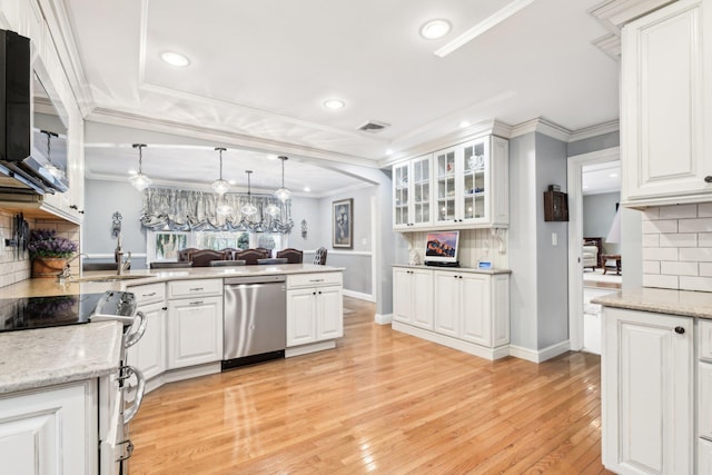 kitchen with appliances with stainless steel finishes, white cabinets, hanging light fixtures, light hardwood / wood-style floors, and crown molding