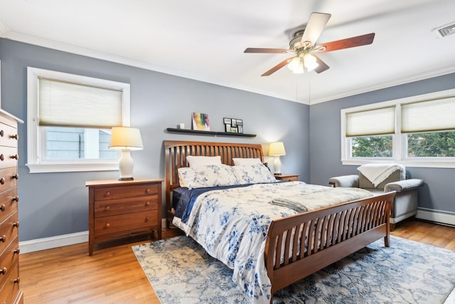 bedroom featuring baseboard heating, ceiling fan, ornamental molding, and light hardwood / wood-style flooring