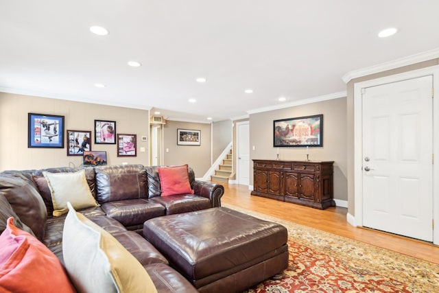 living room with crown molding and light hardwood / wood-style flooring