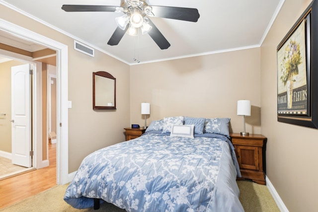 bedroom featuring ceiling fan, ornamental molding, and light wood-type flooring