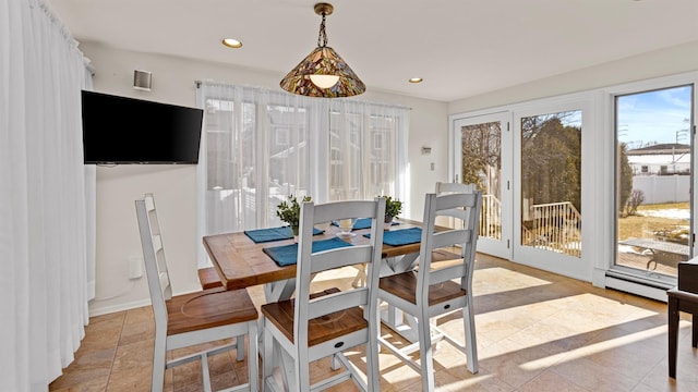 sunroom / solarium featuring baseboard heating