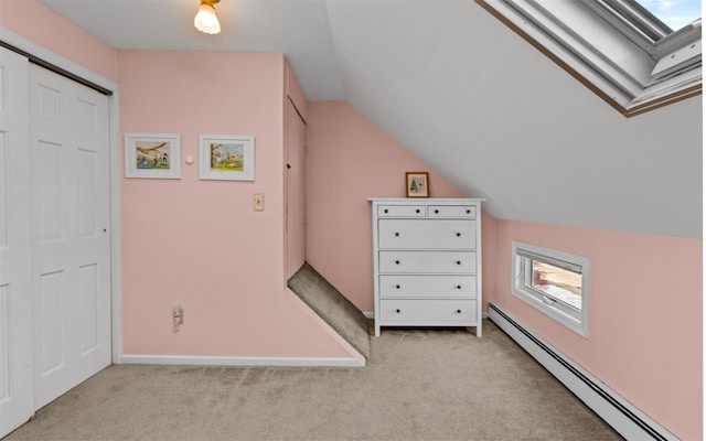 bonus room with vaulted ceiling, light carpet, and a baseboard heating unit