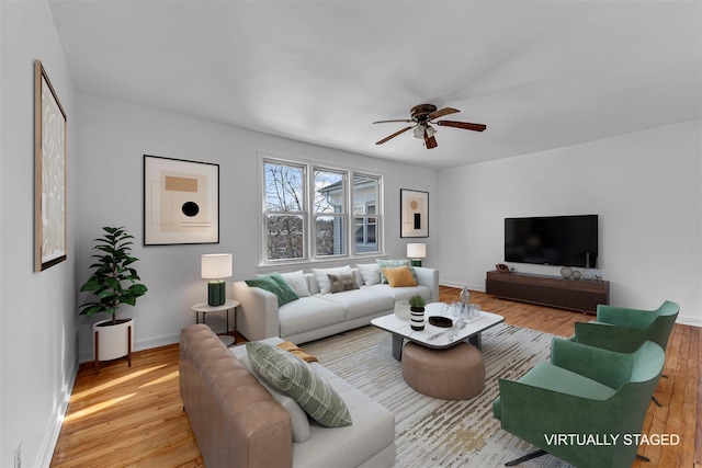 living room with ceiling fan and light hardwood / wood-style flooring