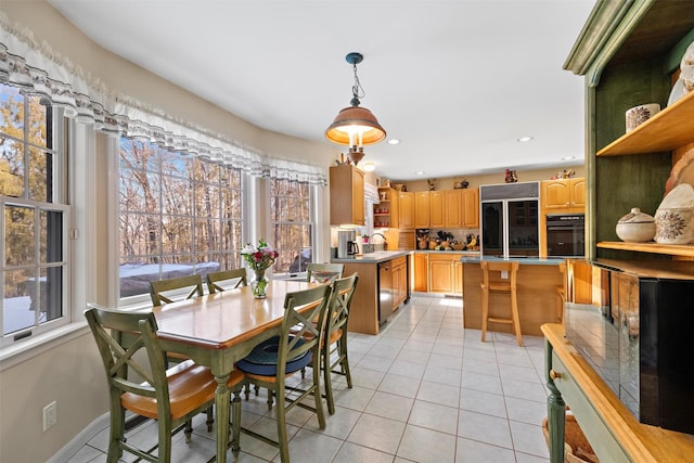 tiled dining area featuring sink