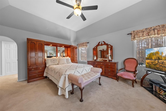 bedroom with light carpet, lofted ceiling, and ceiling fan