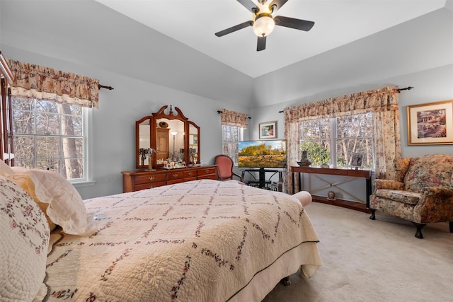 bedroom featuring vaulted ceiling, light colored carpet, and ceiling fan