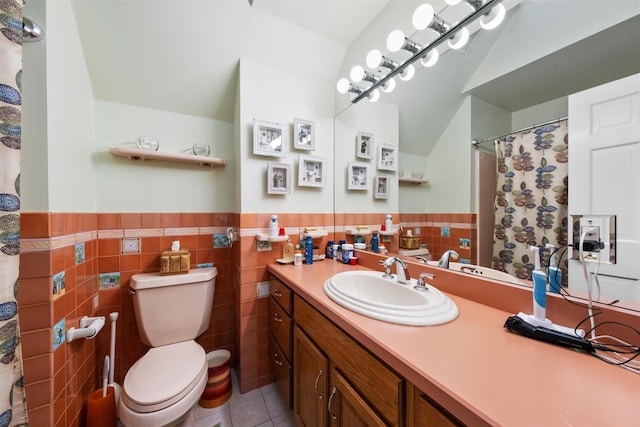 bathroom with tile patterned floors, toilet, tile walls, and vanity