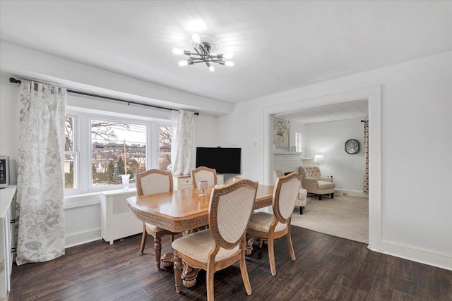 dining room with dark wood-type flooring, radiator heating unit, and a chandelier