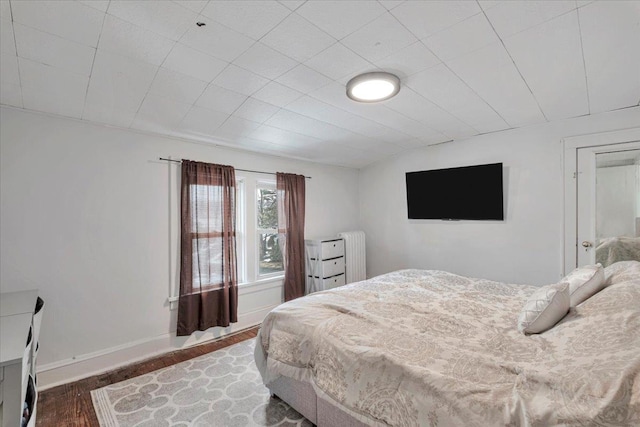 bedroom featuring dark hardwood / wood-style floors and radiator