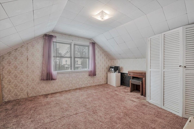 bonus room featuring lofted ceiling and carpet