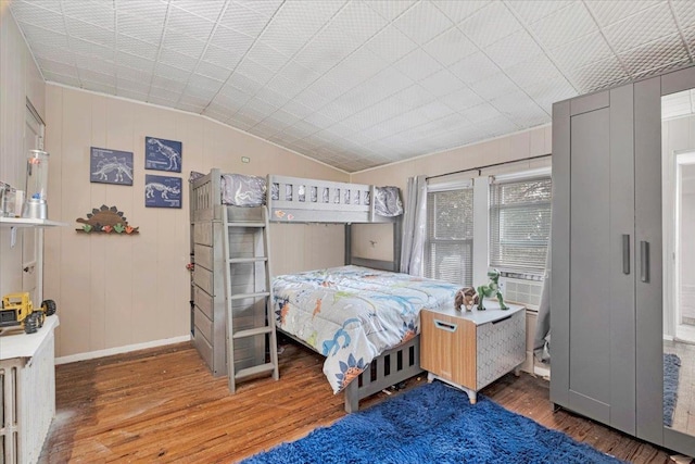 bedroom featuring vaulted ceiling, dark hardwood / wood-style floors, and cooling unit