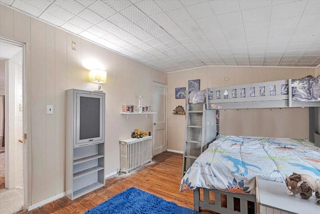 bedroom featuring wood-type flooring and vaulted ceiling