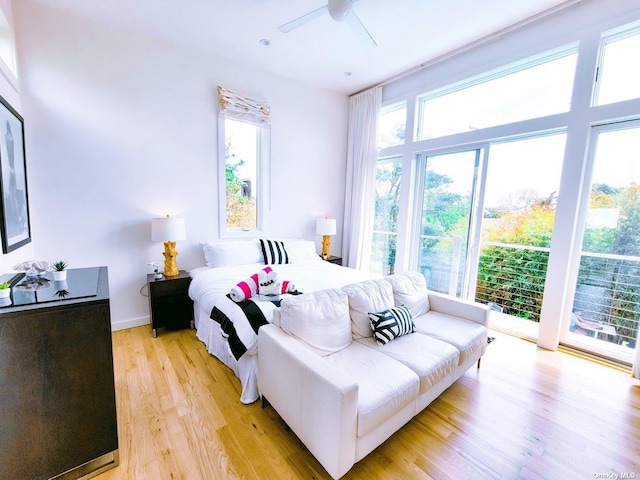 bedroom featuring light hardwood / wood-style flooring, access to outside, and ceiling fan