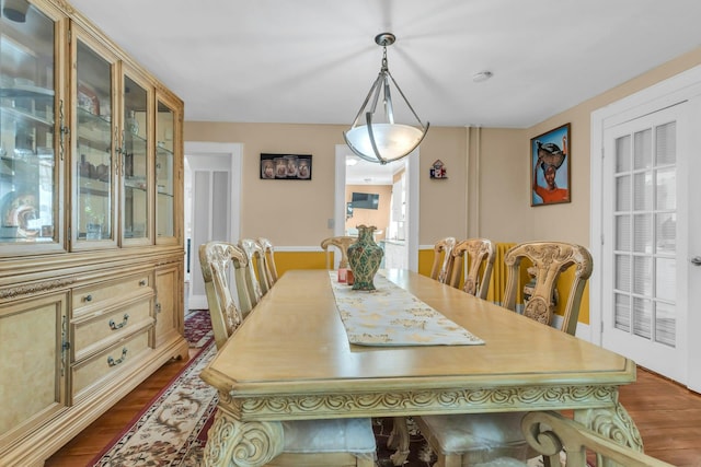 dining area featuring dark wood-type flooring