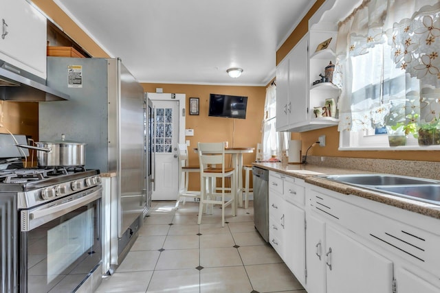 kitchen with ventilation hood, sink, white cabinets, light tile patterned floors, and stainless steel appliances