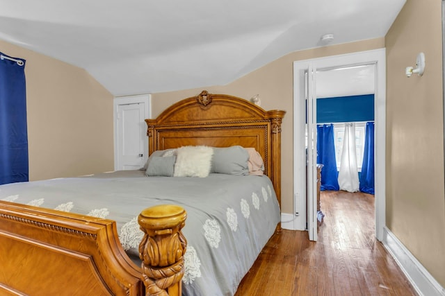 bedroom featuring lofted ceiling and hardwood / wood-style flooring