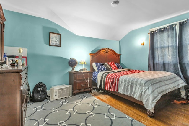 bedroom with vaulted ceiling and light hardwood / wood-style floors