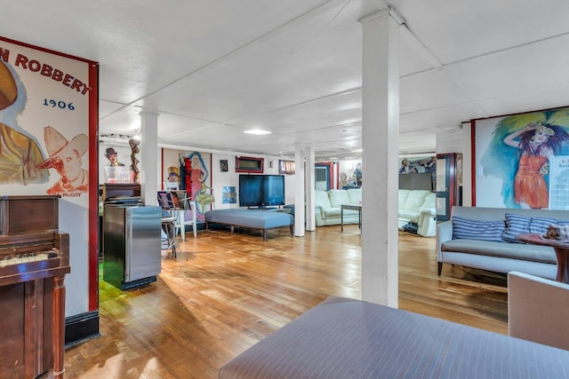 playroom with hardwood / wood-style flooring and decorative columns