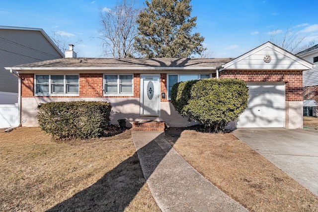 ranch-style home with a garage and a front lawn