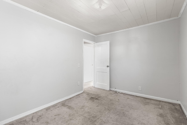 carpeted empty room featuring ornamental molding