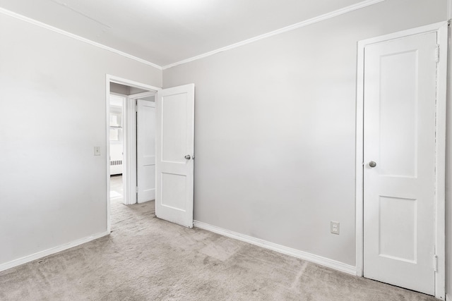 carpeted spare room featuring ornamental molding and radiator