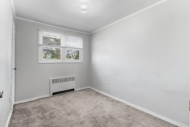 carpeted empty room with ornamental molding and radiator