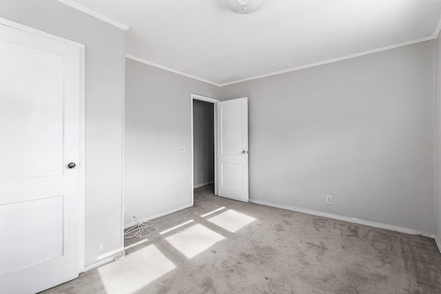 unfurnished bedroom with crown molding and light carpet