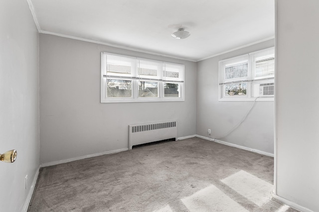 carpeted spare room with ornamental molding, radiator, and cooling unit