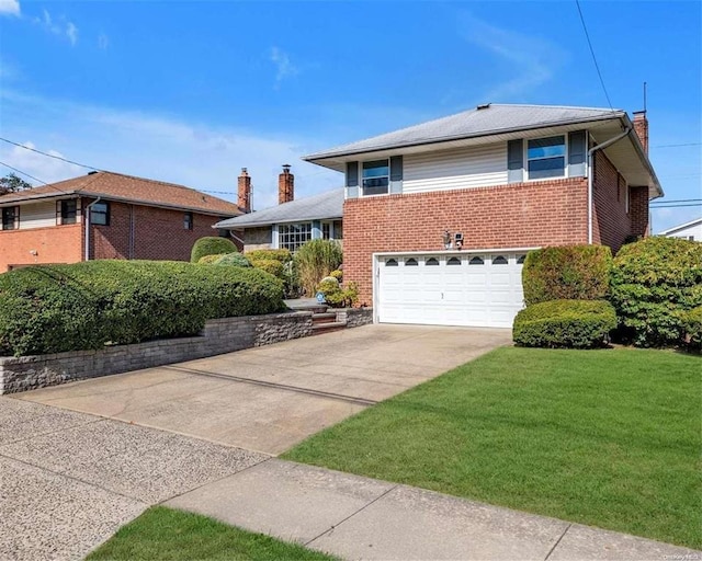 view of front of property with a garage and a front yard