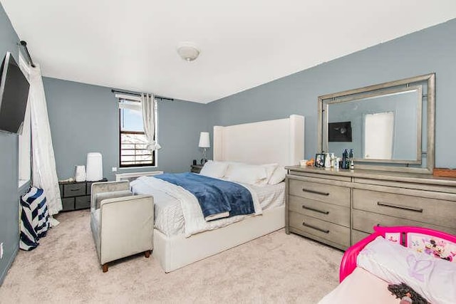 bedroom featuring light colored carpet