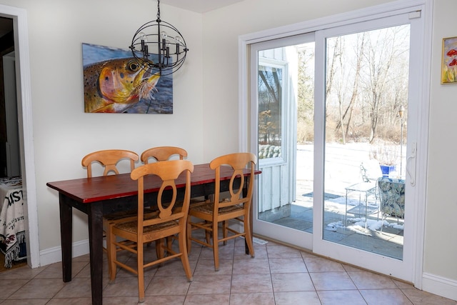 dining room featuring a notable chandelier and light tile patterned floors