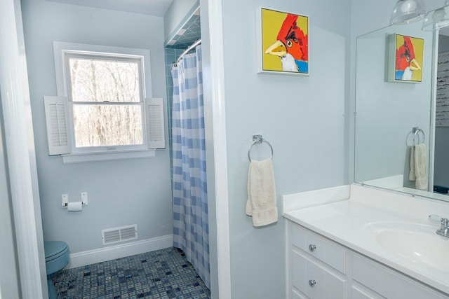 bathroom featuring tile patterned flooring, vanity, curtained shower, and toilet