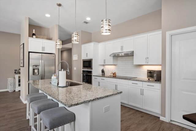 kitchen featuring sink, white cabinets, and decorative light fixtures