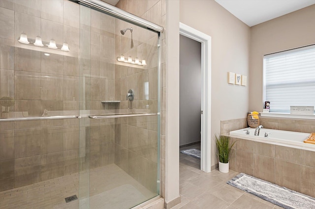 bathroom with tile patterned floors and shower with separate bathtub