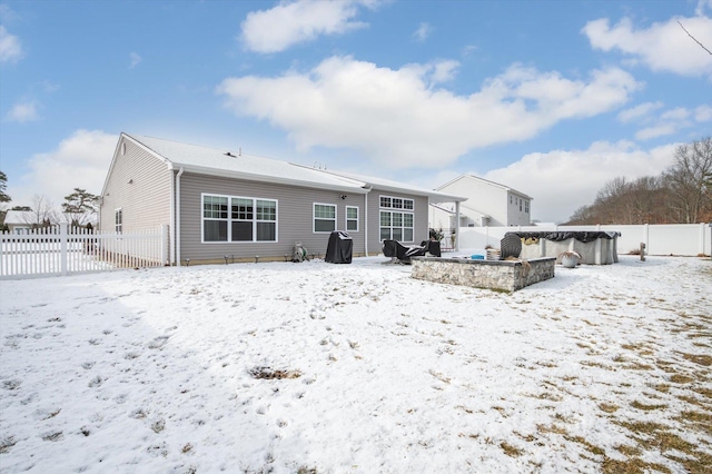 view of snow covered rear of property